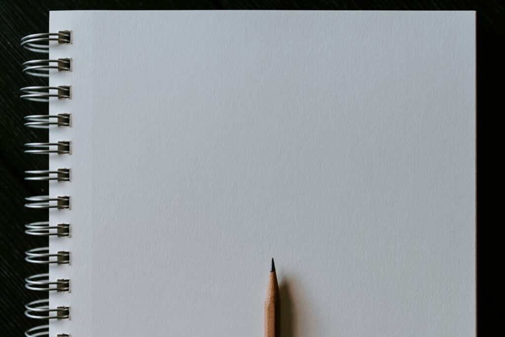 A pencil on a blank notebook
